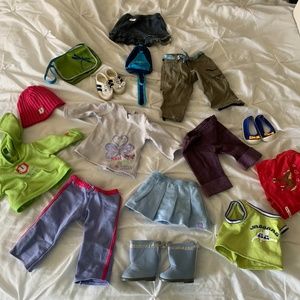 Assortment of American girl doll clothes and accessories